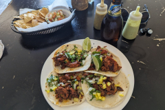 tacos, hot sauces, chips, pico, cold beer