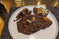 ribeye, baked potato, mushrooms